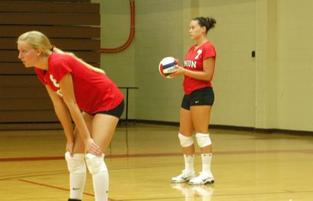 Lindsey Wallach (right) waits for her turn to serve, while Amanda Coyle gets ready for the play. - Photo by Steven Aldridge