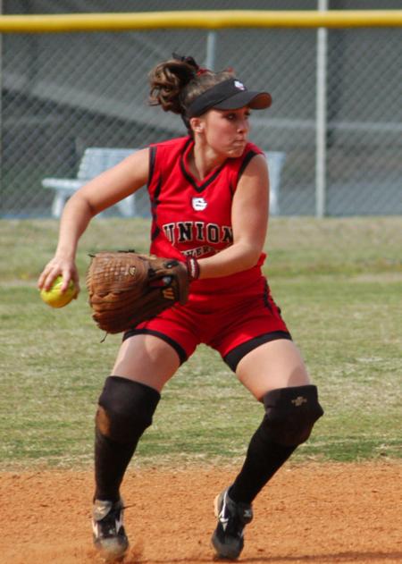 Candace Cross fields the ball and tosses it to first base. - Photo by Steven Aldridge
