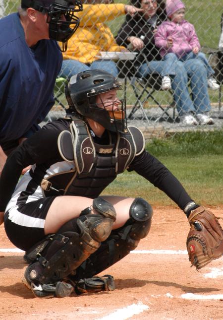 Candice Thompson awaits the pitch in her catching position. - Photo by Steven Aldridge