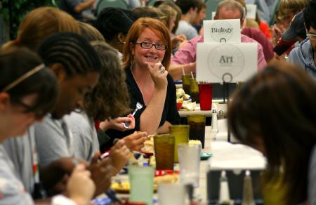 Kathleen Murray, photography instructor, talks with new art students at the dinner with your department event during new student orientation. - Photo by Kristi McMurry Woody