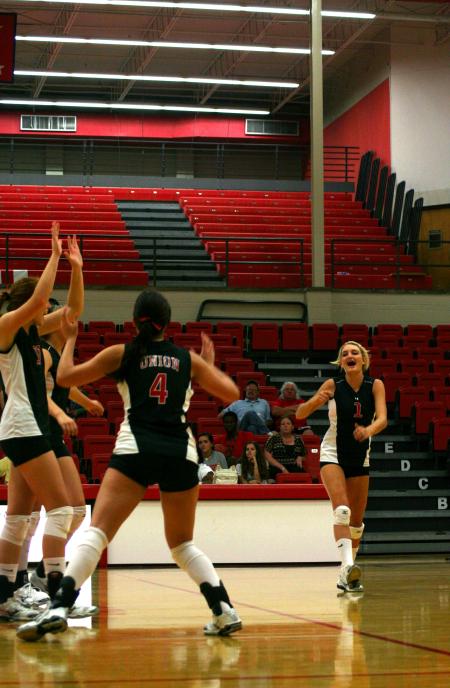Katie Adams, junior, celebrates with her teammates after a point is gained against Martin Methodist.  The Lady Bulldogs won the match 3-0. - Photo by Kristi McMurry Woody