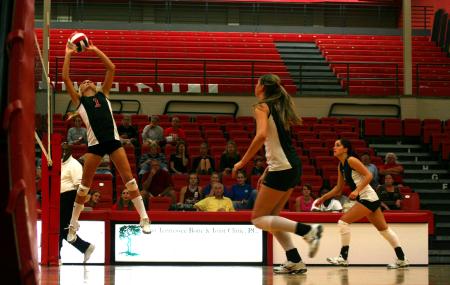 Katie Adams sets the ball for her teammate during a match against Martin Methodist. - Photo by Kristi McMurry Woody