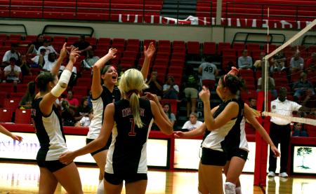 Emilie Ogas, senior, celebrates with the rest of her team after a win against Martin Methodist. - Photo by Kristi McMurry Woody
