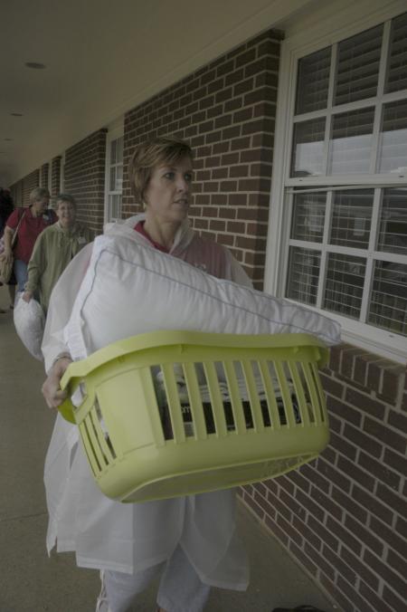 Nursing faculty members Tracy Saddler, Jill Webb and Sandra Brown help freshmen move into the new residence complex. - Photo by Jordan Buie