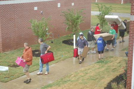 A steady stream of volunteers helped new students move their belongings into the new residence life complex. - Photo by Beth Spain