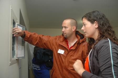 Assistant Dean of Students Bryan Carrier gives light to a few ladies during freshman move-in day. - Photo by Beth Spain