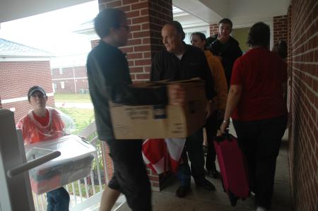 Cramped balconies and tight spaces were quite the norm as parents, students and faculty raced to move freshmen belongings from rainy conditions to the new dorms.  - Photo by Beth Spain