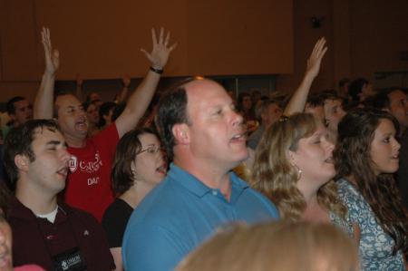 New students and their families offer up praise during the evening worship service. - Photo by Beth Spain