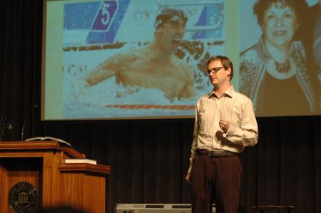 Greg Thornbury, dean of the School of Christian Studies, speaks about Michael Phelps and his mother during the New Student Orientation worship service. - Photo by Beth Spain