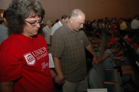 Parents circle around their students to pray over them before leaving them in the care of the Union family. - Photo by Beth Spain