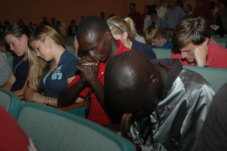 New Union students are lead in a prayer by President Dockery during the Focus evening worship service.  - Photo by Beth Spain
