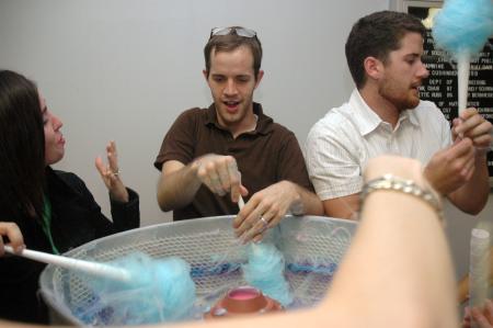 Landon Preston (center) and Lee & Beth Wilson make cotton candy for the new students before the Focus show. - Photo by Beth Spain
