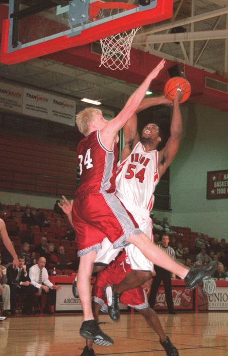 Senior Derrick Underwood gets a burst of energy as he shoots for two over an opposing Lyon. - Photo by Lindsay Stavish