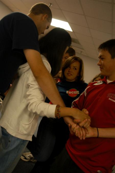 Katherine Lamar's FOCUS group tries to untangle themselves from a human knot during a team building exercise. - Photo by Angela Abbamonte