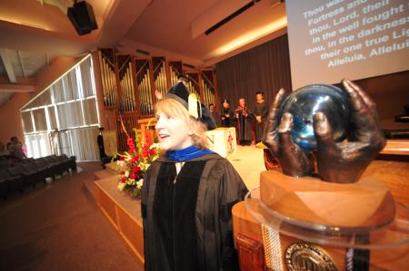 Jeanette Russ, 2008-09 faculty member of the year, stands with the university mace at the beginning of the fall convocation service. - Photo by Morris Abernathy