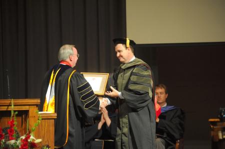 President Dockery installs David Kuhl as the Baptist Memorial Health Care Chair of Pharmacy during fall convocation. - Photo by Morris Abernathy