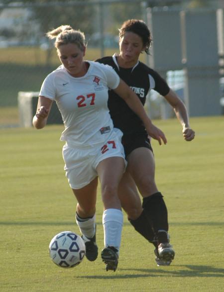 Katelin Dirksen controls the ball as she attempts to move away from the defenders. - Photo by Tommy Sadler
