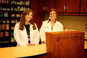 Kate Wilcoxen and Erica King pose in the pharmacy department.