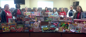 Photo of the NCPA members with toys and canned food collected.