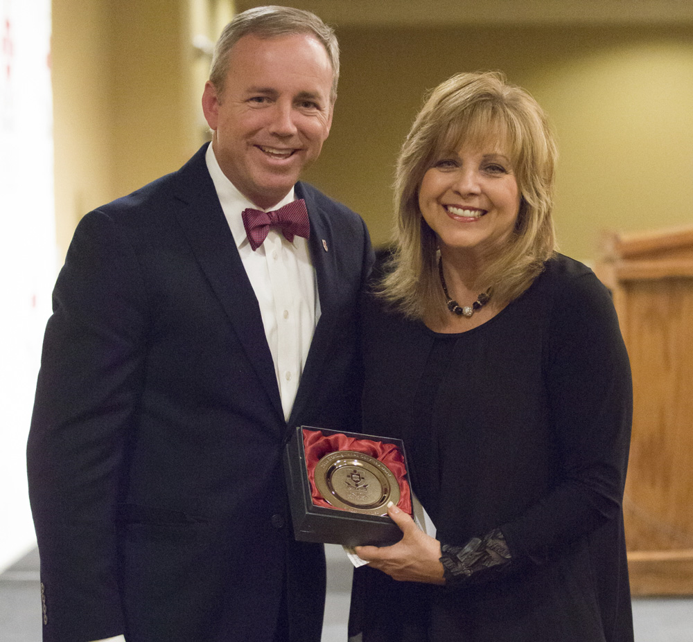 Absher's wife Beverly accepts the award