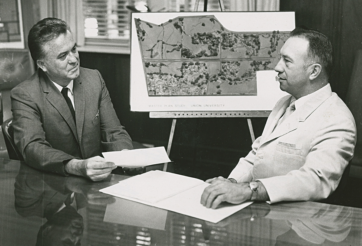 Craig displays map of new campus in the early 70s.