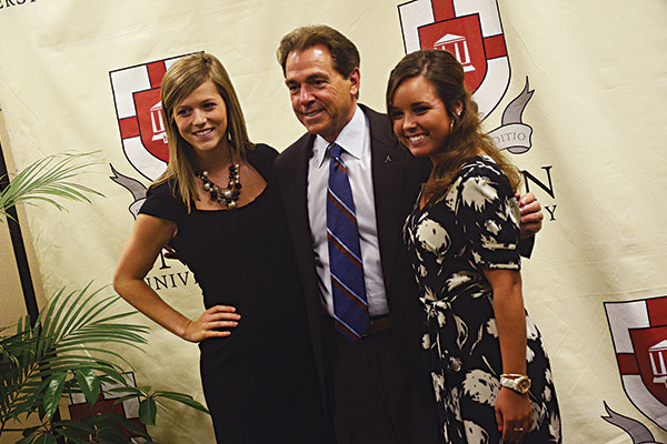 Brittney Teel, junior nursing major, and Hannah McGehee, freshman music major, get their picture taken with Nick Saban, head football coach at the University of Alabama, at the Roy L. White Legacy Golf and Gala where Saban was the speaker