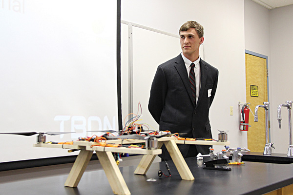 Kenneth Mayo, senior engineering major, stands behind the GoPro drone that his group made for the Scholarship Symposium.