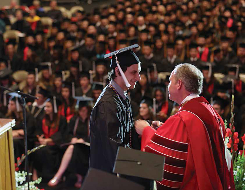 Andrew Clark, art graduate, accepts his diploma from Dr. Dub at the May 16 spring commencement. - photo by Amanda Rohde ('16)