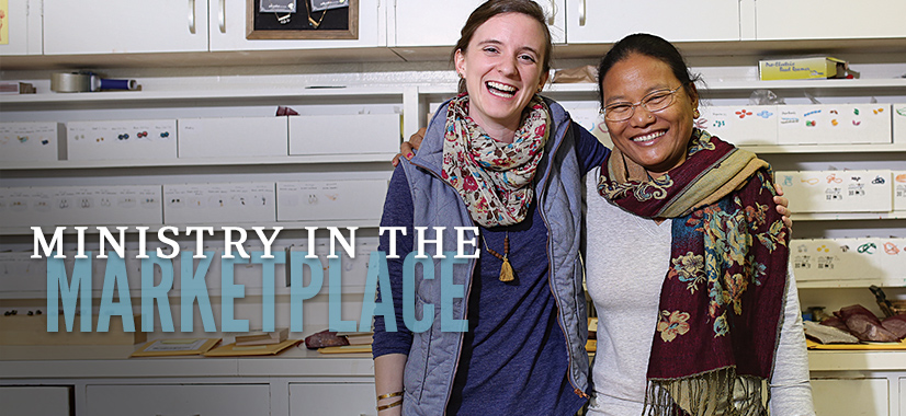 Two women stand smiling with arms around each other in a Christian workspace. Shelves and boxes of supplies are visible in the background. Text on the image reads Ministry in the Marketplace.