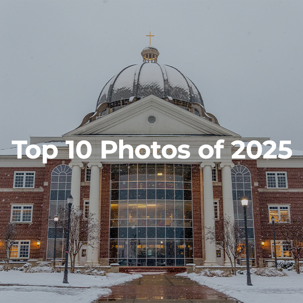 A large domed building with tall columns and a glass entrance is shown in winter, surrounded by snow. Text over the image reads, Top Photos 2025.