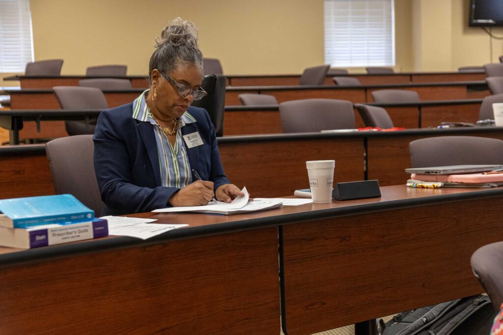 Nurse administration student studying in Jackson classroom.